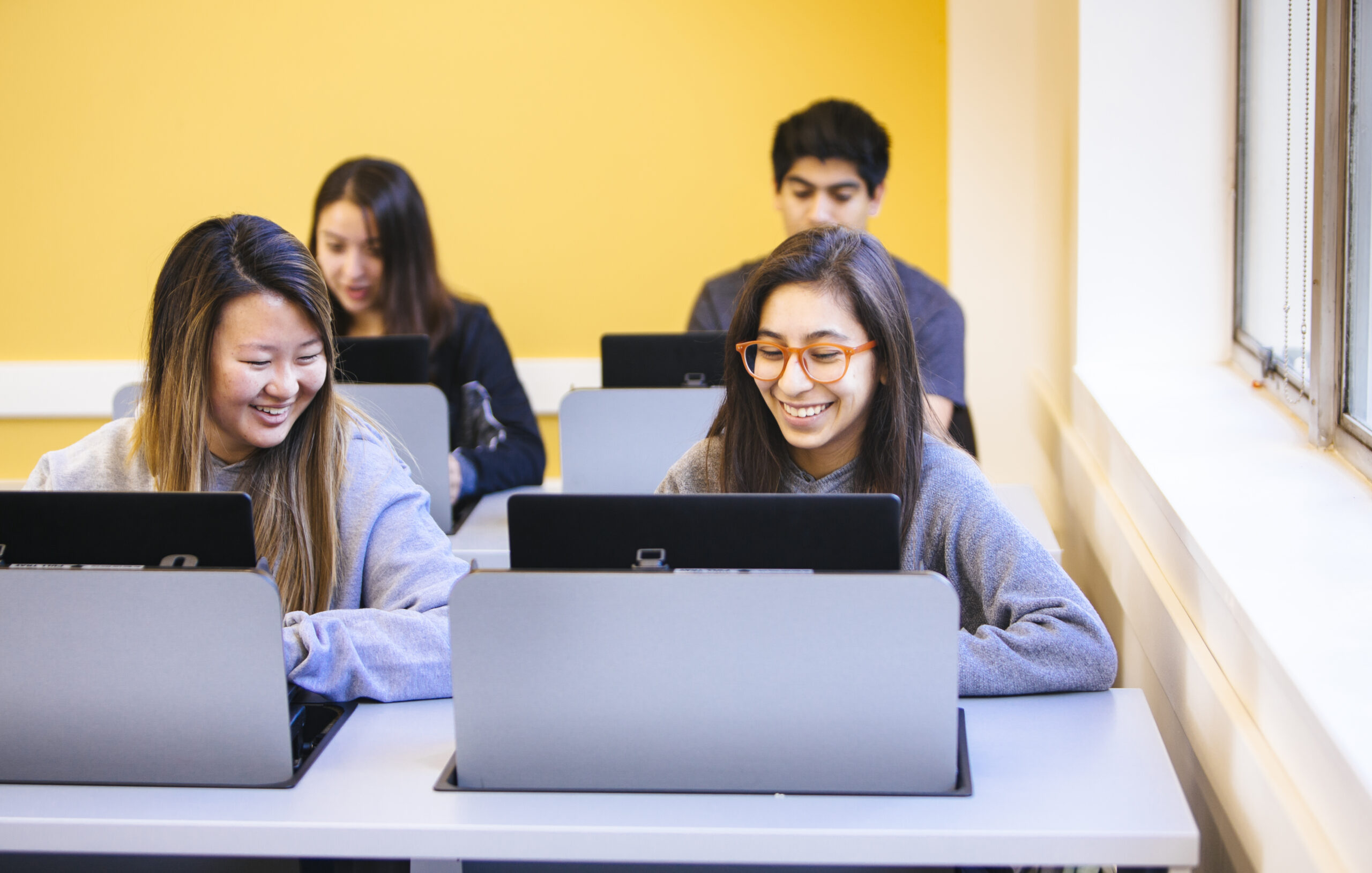 Students viewing something pleasant on their laptops